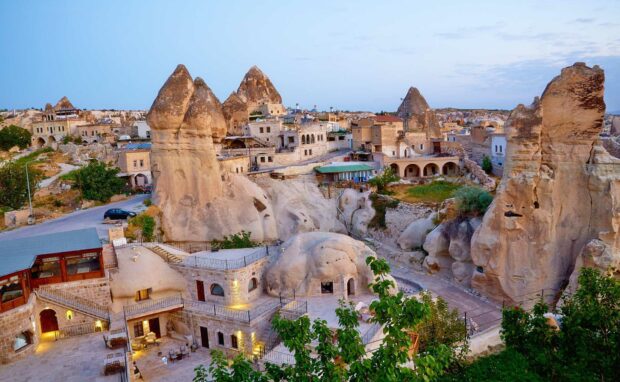 The image shows unique rock formations and ancient buildings in Cappadocia, highlighting the region's historical landscape, HD Desktop Wallpaper