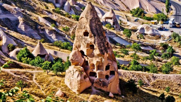 The ancient rock dwellings in Cappadocia offer a glimpse into historical living, surrounded by a rugged landscape, HD Desktop Wallpaper