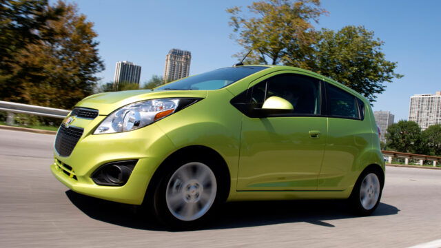 Vibrant Green Chevrolet Spark In Motion Wallpaper