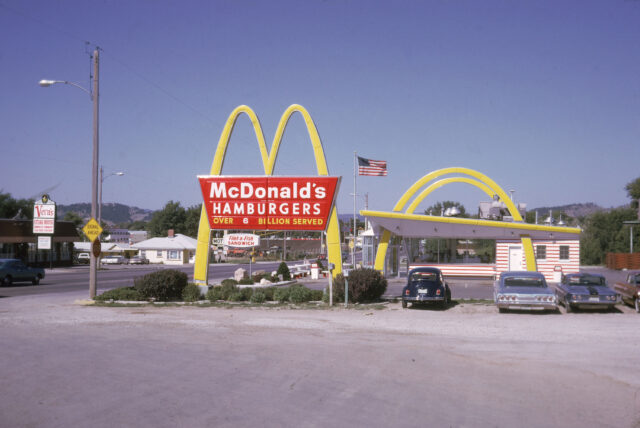Vintage McDonalds Hamburgers Restaurant with Classic Golden Arches and Old Cars Wallpaper