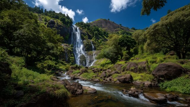 Waterfall Ultra HD Desktop Wallpaper, Majestic Waterfall Cascading Through Lush Greenery Under A Bright Blue Sky