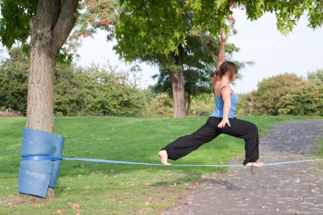 Woman Balancing on Blue Slackline in Park Nature Outdoors Slacklining Wallpapers