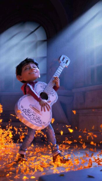 A young boy plays a decorated guitar with joy while surrounded by glowing orange petals in a softly lit room, 2K Phone Wallpaper