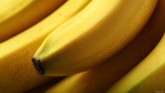 banana desktop wallpaper HD, a close up view of ripe bananas highlighting their smooth textures and rich color tones.