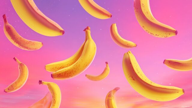 banana desktop wallpaper free download, a whimsical arrangement of bananas against a gradient sunset sky in bright hues.