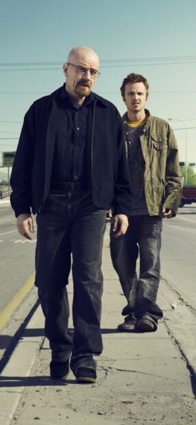 Aaron Paul and Bryan Cranston walk down a sunny street in casual clothes, 2K Phone Wallpaper