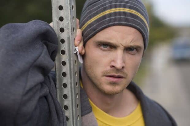 Aaron Paul stares intensely while leaning on a metal pole outside, HD Desktop Wallpaper