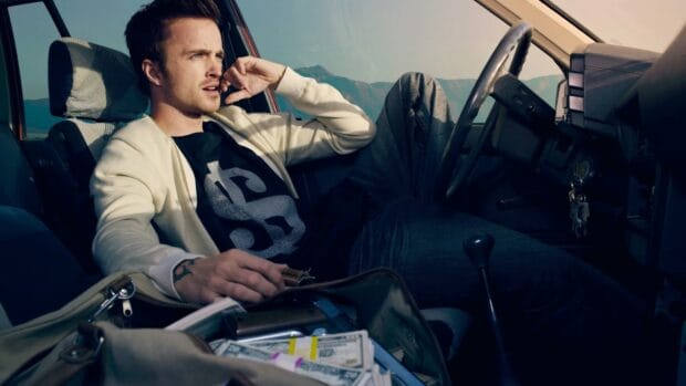 Aaron Paul Wallpapers shows a man sitting in a car with money in a bag on the seat, HD Desktop Wallpaper