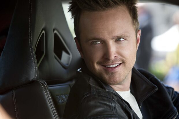 Aaron Paul smiling while sitting in a car seat wearing a leather jacket, HD Desktop Wallpaper