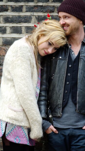 Aaron Paul wallpapers, Aaron Paul smiles while a woman leans on him against a brick wall, 4K Phone Wallpaper