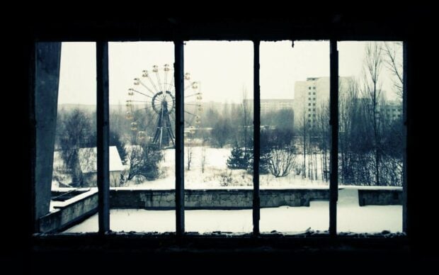 A snowy ghost town with an abandoned ferris wheel seen through broken windows, HD Desktop Wallpaper