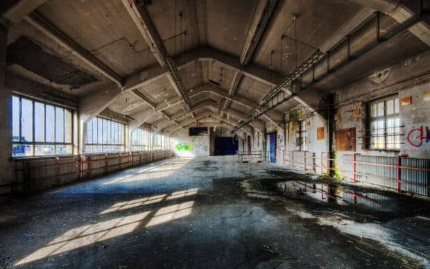 An abandoned industrial hall with sunlight casting shadows in the ghost town, HD Desktop Wallpaper