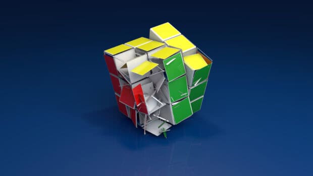 A vibrant broken cube design displays red yellow and green panels scattered on a blue surface, HD Desktop Wallpaper