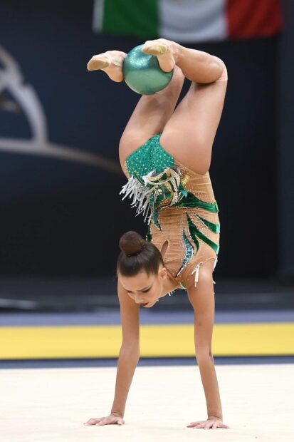 A gymnast performs an acrobatic gymnastics routine balancing a ball while inverted, HD Mobile Wallpaper