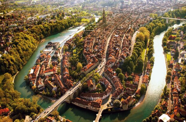 Aerial view of the River Aare Switzerland flowing through the city surrounded by greenery and buildings, HD Desktop Wallpaper