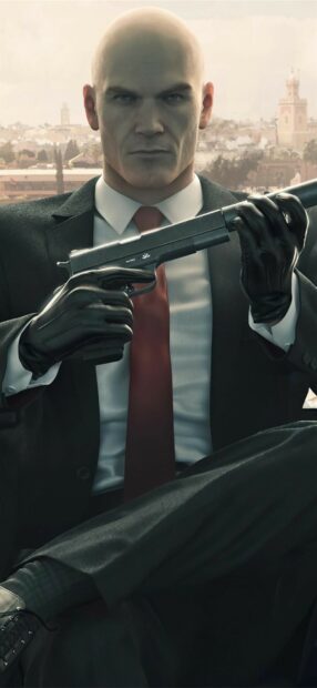 Agent 47 is holding a silenced pistol outdoors in the Hitman game, HD Mobile Wallpaper