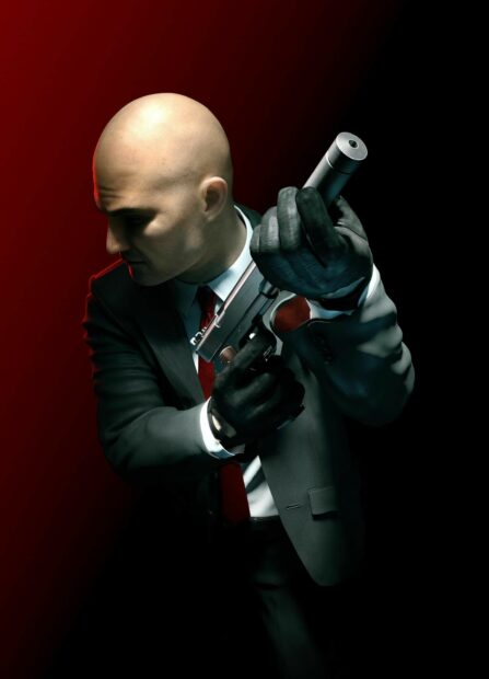 A bald agent prepares his silenced pistol in a dark room with red lighting in the Hitman game, HD Mobile Wallpaper