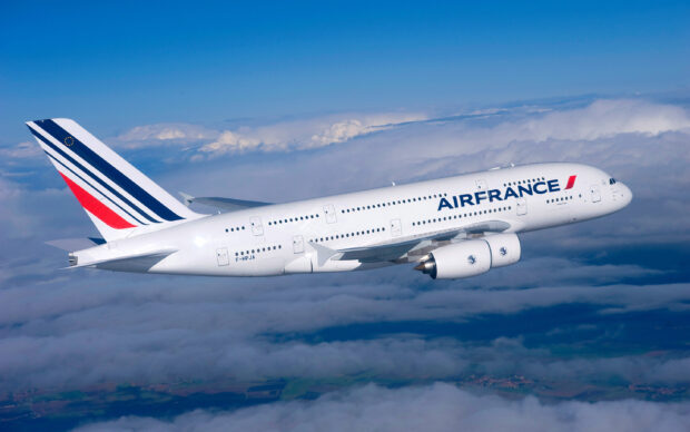 An Air France Airbus A380 is captured flying above the clouds in a clear blue sky, 2K Desktop Wallpaper