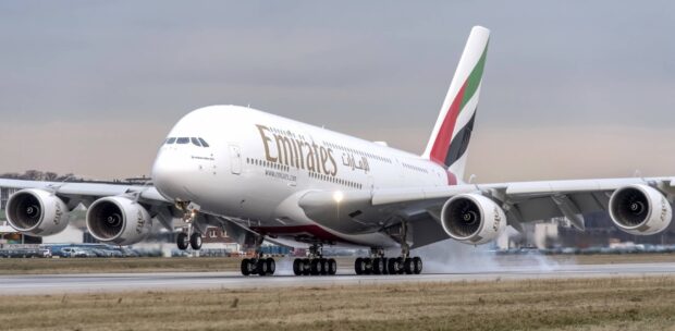 An Emirates Airbus A380 is landing on a runway with smoke from the tires visible, HD Desktop Wallpaper