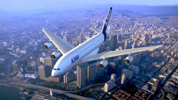An Airbus A380 flying high above a detailed cityscape during the day, HD Desktop Wallpaper
