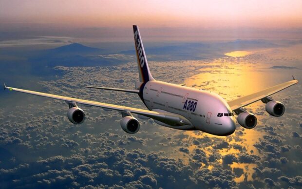 An Airbus A380 is flying above clouds during a colorful sunset sky, HD Desktop Wallpaper