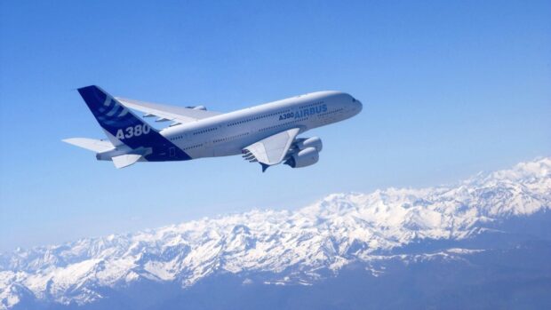 An Airbus A380 flies above snow covered mountains under a clear blue sky, HD Desktop Wallpaper