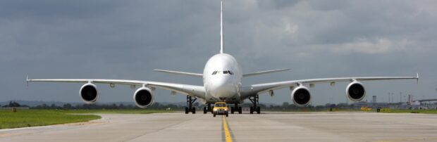 An Airbus A380 sits on the runway under cloudy skies with a service vehicle in front, 4K Desktop Wallpaper