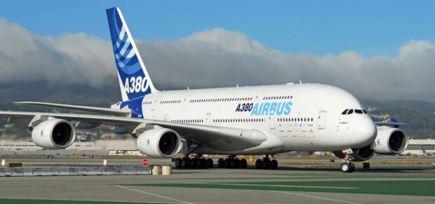 The Airbus A380 is parked on the runway with mountains and clouds in the background, HD Desktop Wallpaper