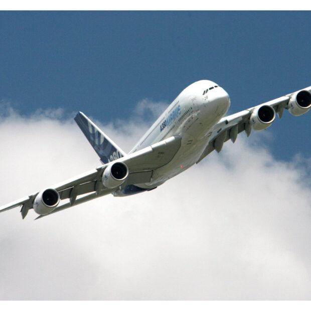 An Airbus A380 aircraft is flying high in the blue sky with clouds below, HD Desktop Wallpaper
