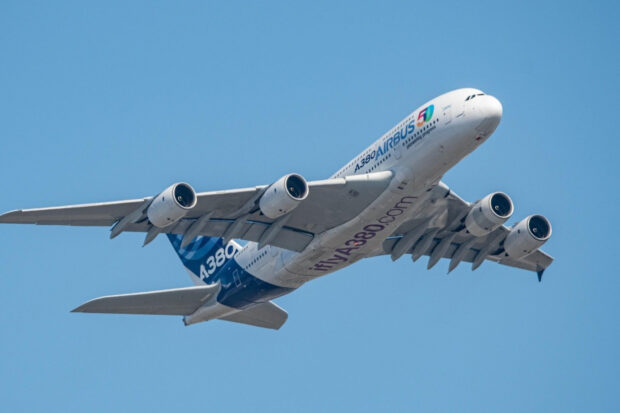 A large Airbus A380 aircraft is flying smoothly through a clear blue sky, HD Desktop Wallpaper