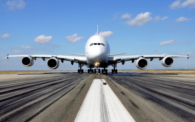 A large Airbus A380 is lined up on the runway with clear skies, 2K Desktop Wallpaper