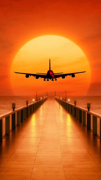 An aircraft is flying toward a pier with the sun setting in the background, 2K Mobile Wallpaper