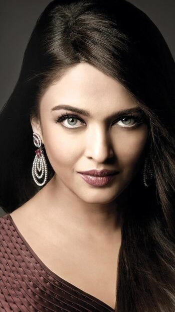 A close up portrait of Aishwarya Rai with striking eyes and elegant earrings, 4K Phone Wallpaper