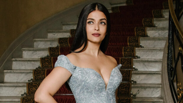 Aishwarya Rai stands confidently wearing a detailed pale blue dress on a grand staircase, HD Desktop Wallpaper