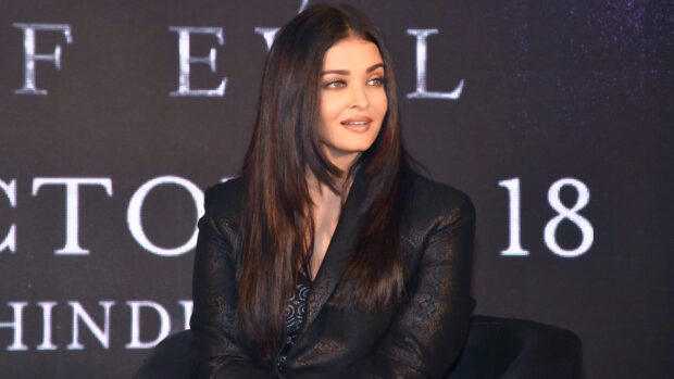 Aishwarya Rai is sitting and looking to the side wearing a black jacket, HD Desktop Wallpaper