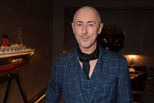 Alan Cumming is wearing a blue plaid suit with a black scarf indoors, HD Desktop Wallpaper