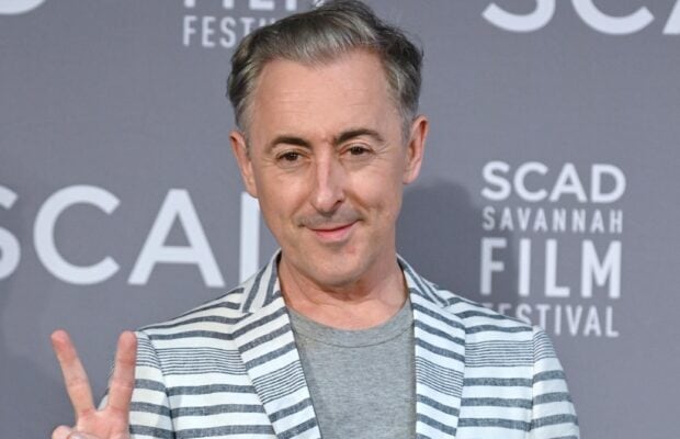 Alan Cumming smiles while posing at a film festival event, 2K Desktop Wallpaper
