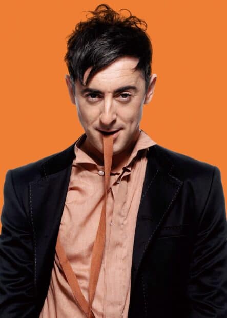 Alan Cumming poses with a playful expression and orange tie, HD Mobile Wallpaper