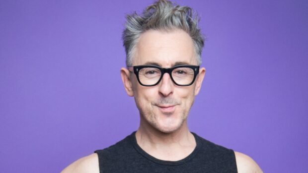 Alan Cumming is smiling while wearing black glasses and a sleeveless shirt, HD Desktop Wallpaper