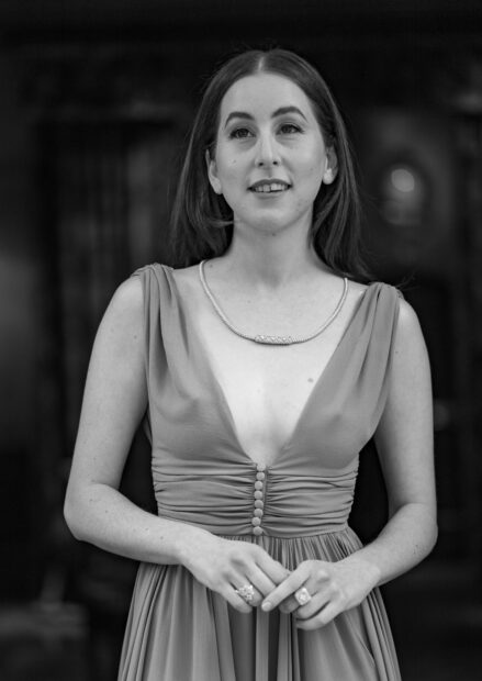 Alana Haim is wearing a detailed dress and jewelry in this black and white portrait, HD Phone Wallpaper