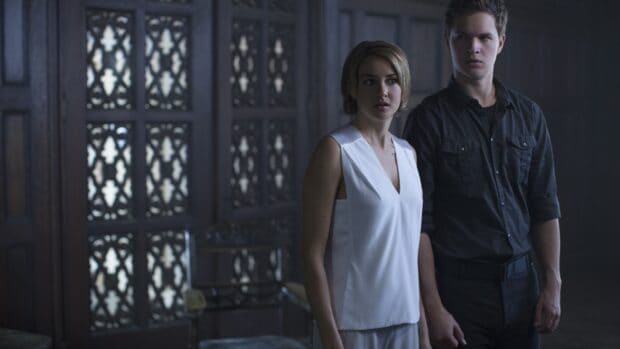 Two Allegiant characters stand tense inside a dimly lit room, 2K Desktop Wallpaper