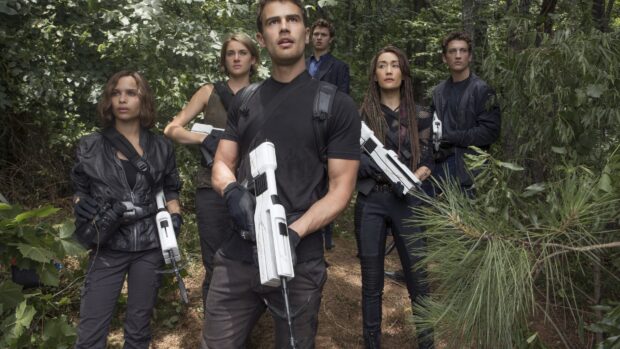 A group of six people holding futuristic weapons in a forest from Allegiant Wallpapers movie, 4K Desktop Wallpaper