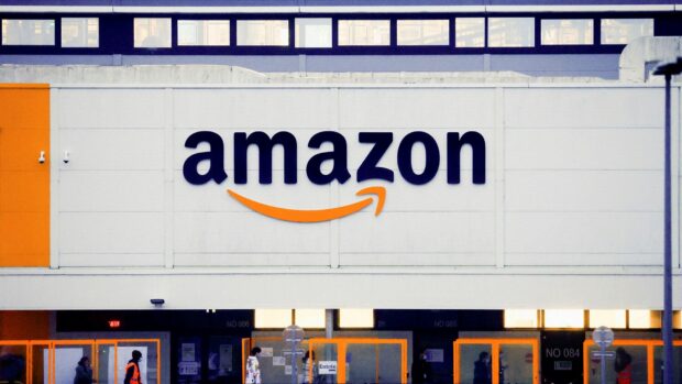 The Amazon logo is clearly displayed on a white building wall with orange accents, HD Desktop Wallpaper