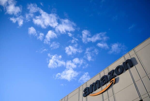The Amazon Wallpapers logo stands clearly on the building facade under a bright blue sky, HD Desktop Wallpaper