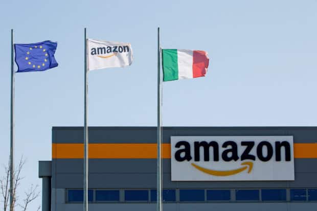 The Amazon logo is seen on a building with European Union and Italian flags flying nearby, HD Desktop Wallpaper