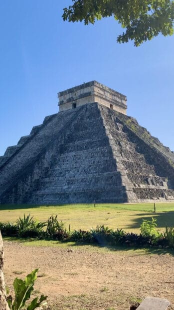 The Chichen Itza pyramid stands tall under a clear blue sky surrounded by greenery, HD Phone Wallpaper