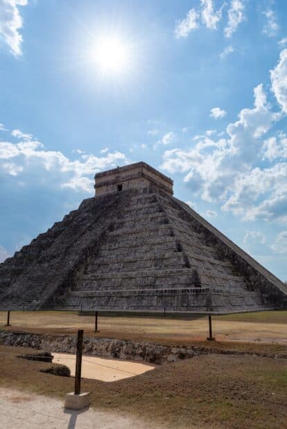 The Chichen Itza pyramid stands tall under a bright sunny sky with scattered clouds, HD Mobile Wallpaper