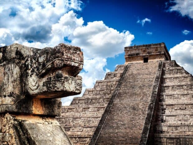 The Chichen Itza stone serpent carving stands prominently near the pyramid under a cloudy sky, HD Desktop Wallpaper