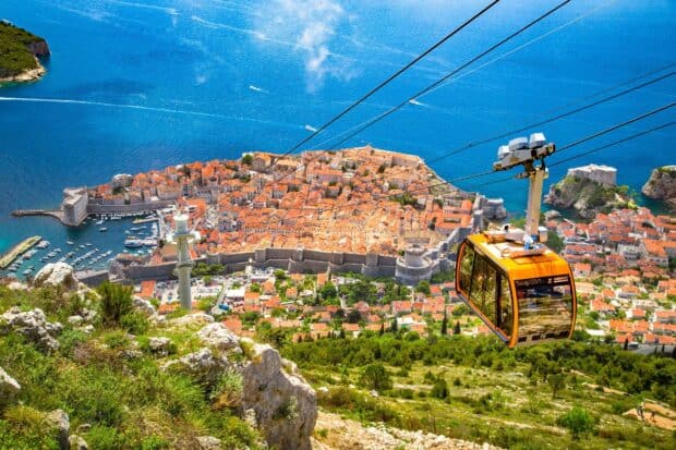 A cable car overlooks the ancient city walls Dubrovnik with the sea in the background, HD Desktop Wallpaper