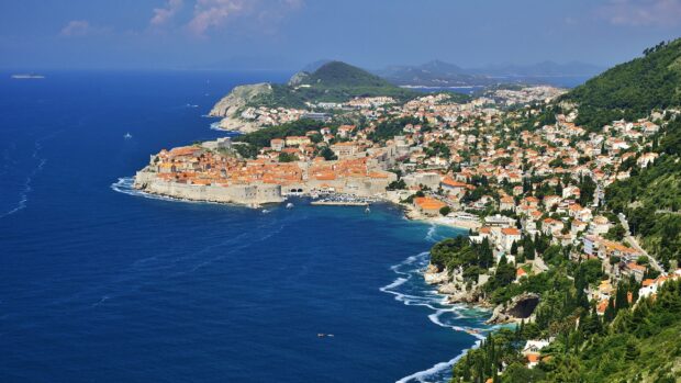 A stunning view of ancient city walls in Dubrovnik along the Adriatic Sea, 2K Desktop Wallpaper